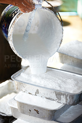 Buy stock photo A man pouring liquid rubber into molds to set. Professional worker technician spilling soft liquid rubber in mold in factory production workplace. Manufacturer working the operating process 