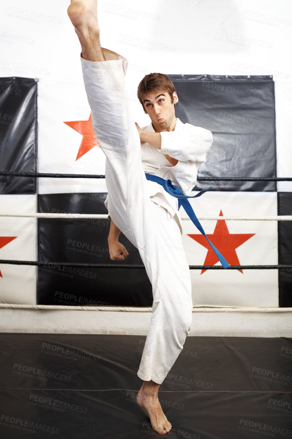 Buy stock photo Man, karate and high kick for martial arts in ring, self defense or jiujitsu training for fighting match. Male person, athlete or fighter in MMA boxing, muay thai or fitness practice at dojo or gym