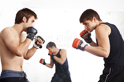 Buy stock photo Men, fighting and martial arts training in ring with sparring partner for self defense techniques at dojo. Male person or fighter in kick boxing, karate or MMA for jujitsu match, sports or face off