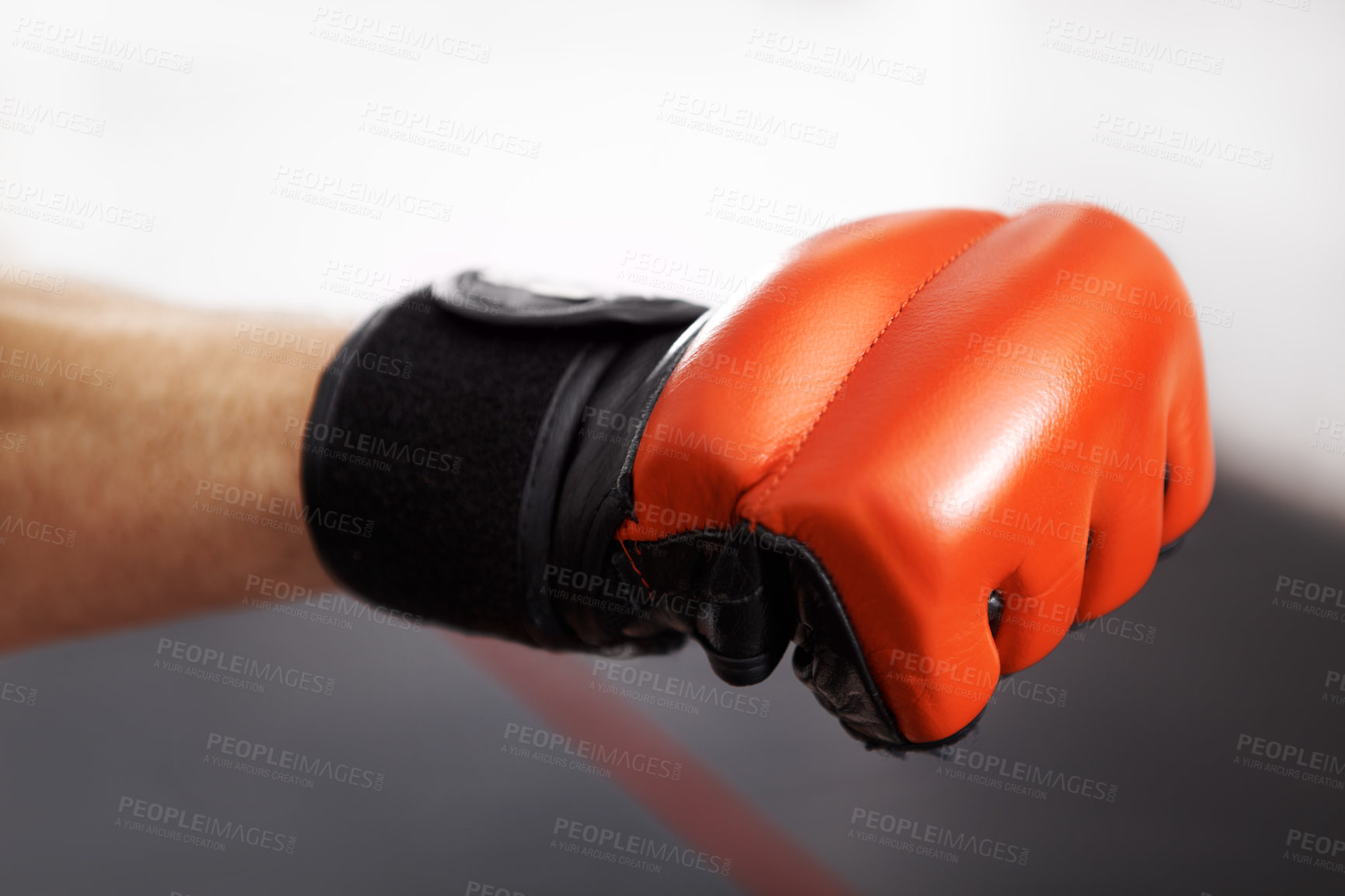Buy stock photo Cropped shot of a martial artist's fist in a red kickboxing glove
