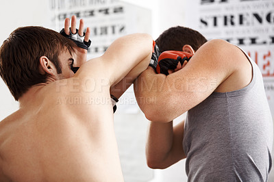 Buy stock photo Man, fighting and martial arts with elbow block or sparring partner for self defense techniques at dojo. Male person or fighter in kick boxing, karate or MMA for jujitsu, protection or guard at gym