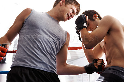 Buy stock photo Cropped shot of two martial artists sparring in the ring