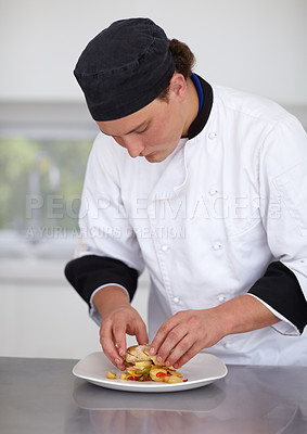 Buy stock photo Young chef preparing a chicken dish in a kitchen - Fine Dining