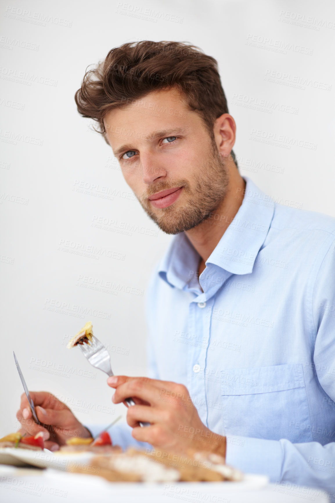 Buy stock photo Handsome young man enjoying a meal in a fine restaurant