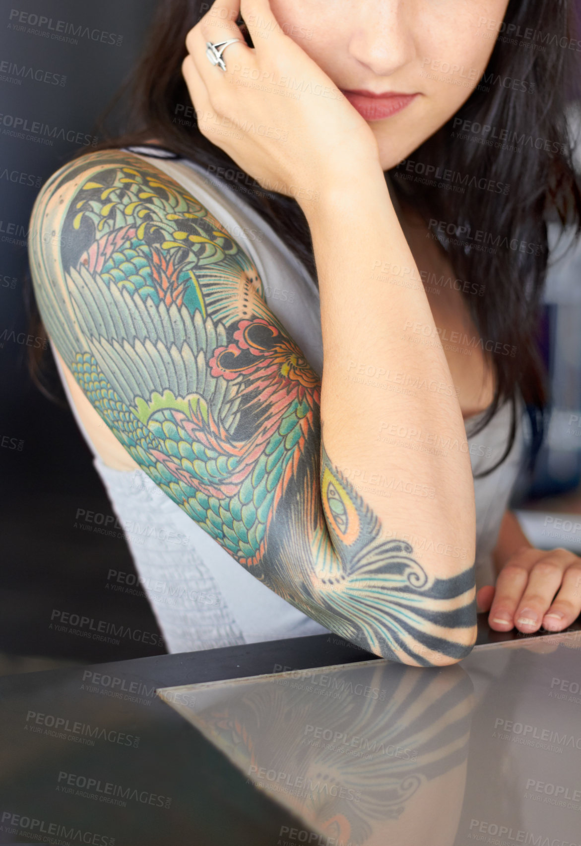 Buy stock photo Cropped shot of a young tattoo artist showing off her half-sleeve tattoo 