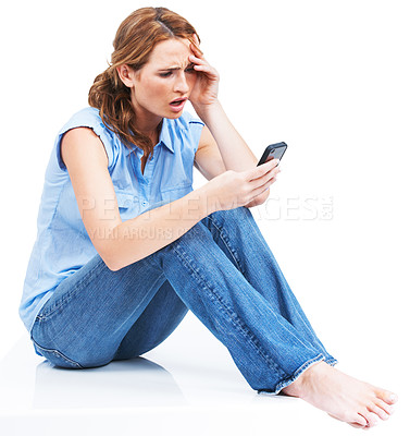 Buy stock photo Beautiful young woman reading a text message in disbelief