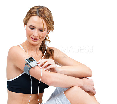 Buy stock photo Fitness, music player and a sports woman in studio isolated on a white background for a break from her workout. Exercise, health and a young athlete listening to earphones training for wellness