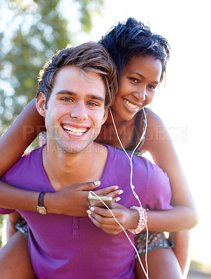 Buy stock photo Fitness, portrait and happy couple with piggyback hug outdoor for training, bond or fun. Interracial, love and face of active man with back ride for woman with music, earphones or audio track device