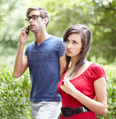 Buy stock photo Couple fight, phone call and woman frustrated by cheating man, liar or bored with relationship in a park. Smartphone, conflict and annoyed female rolling eyes for workaholic boyfriend in a forest
