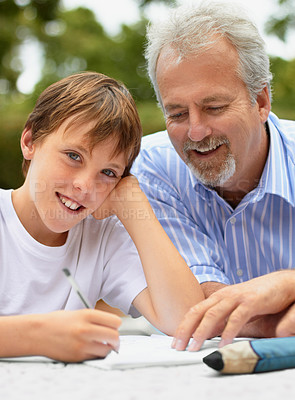 Buy stock photo Shot of a father helping his son with his homework