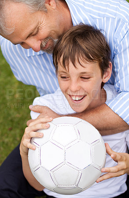 Buy stock photo Happy, playing and a father with a child for soccer, game and a competition in the backyard. Smile, laughing and a dad or man and boy kid with a football for training, workout or sports in a garden