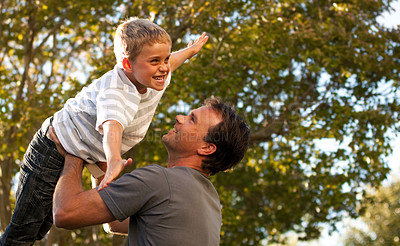 Buy stock photo Dad, child and garden with airplane game, happy bonding and fun morning playing for father and son. Outdoor fun, love and playful energy, man holding boy in air and laughing in backyard together.