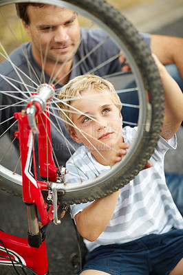 Buy stock photo Bicycle, repair and father help child with bike and learning to fix wheel and parent support kid in vacation or holiday. Smile, development and dad together with son and teaching outdoor skills