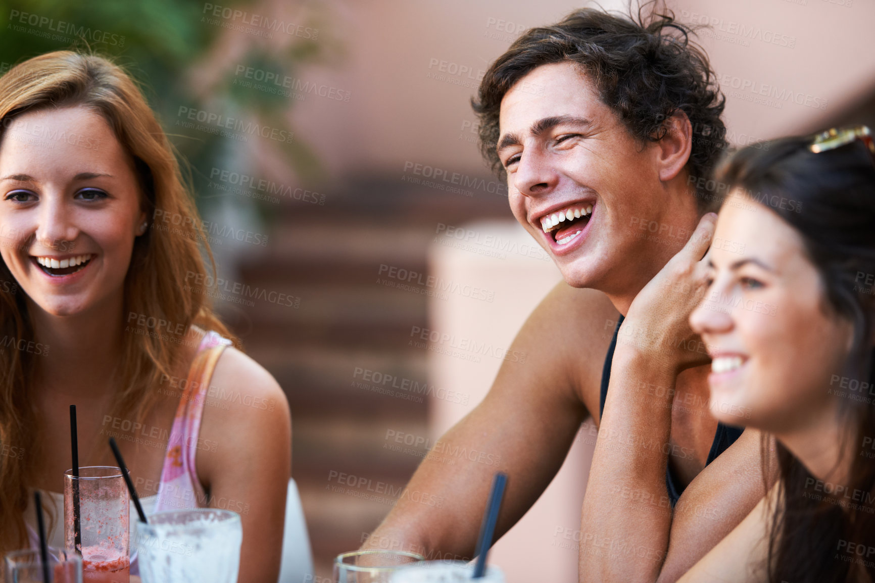Buy stock photo Friends, people and relax with laughter at restaurant, bonding and social gathering with happiness outdoor. Comedy, together and fun at diner, young man and women having drinks with communication