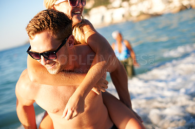 Buy stock photo Piggy back, beach and couple with vacation, travel and happiness with summer break, journey and tourism. People, man carrying woman or traveller with seaside holiday, fun or ocean with joy or excited