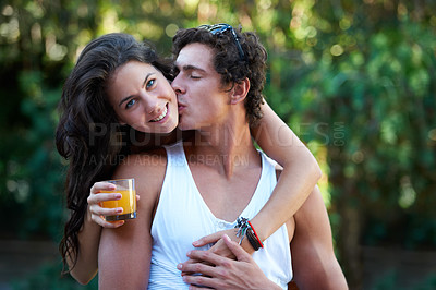 Buy stock photo Happy, couple and hug with kiss outdoor in backyard for bbq with love, care and support at home. Juice, woman and smile in garden with portrait and young people together with glass and date in summer