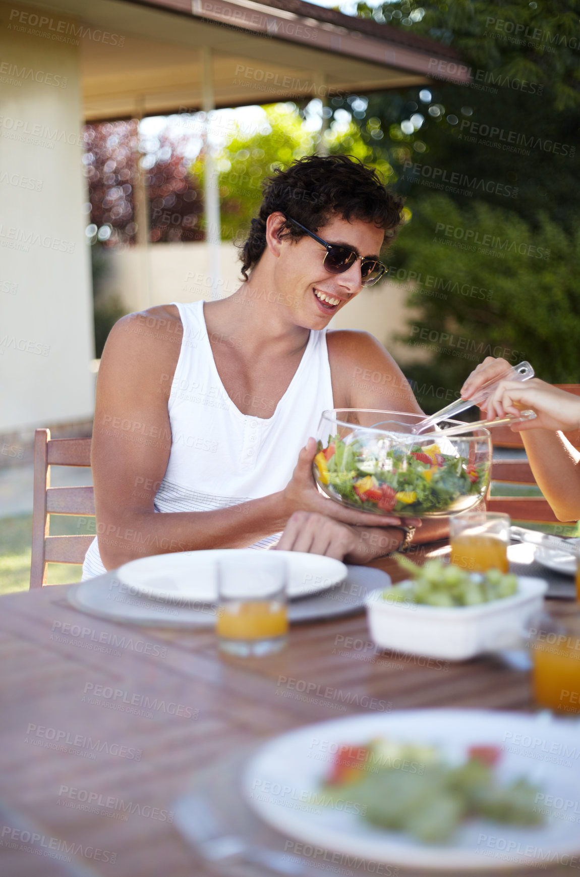 Buy stock photo Happy man, salad and garden with meal and food in summer with teen and health for eating. Table, backyard and young male person with a smile and sunglasses on vacation with lunch outdoor of a home