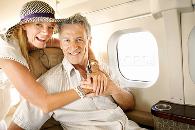 Buy stock photo Smiling senior couple on an airplane heading overseas - portrait