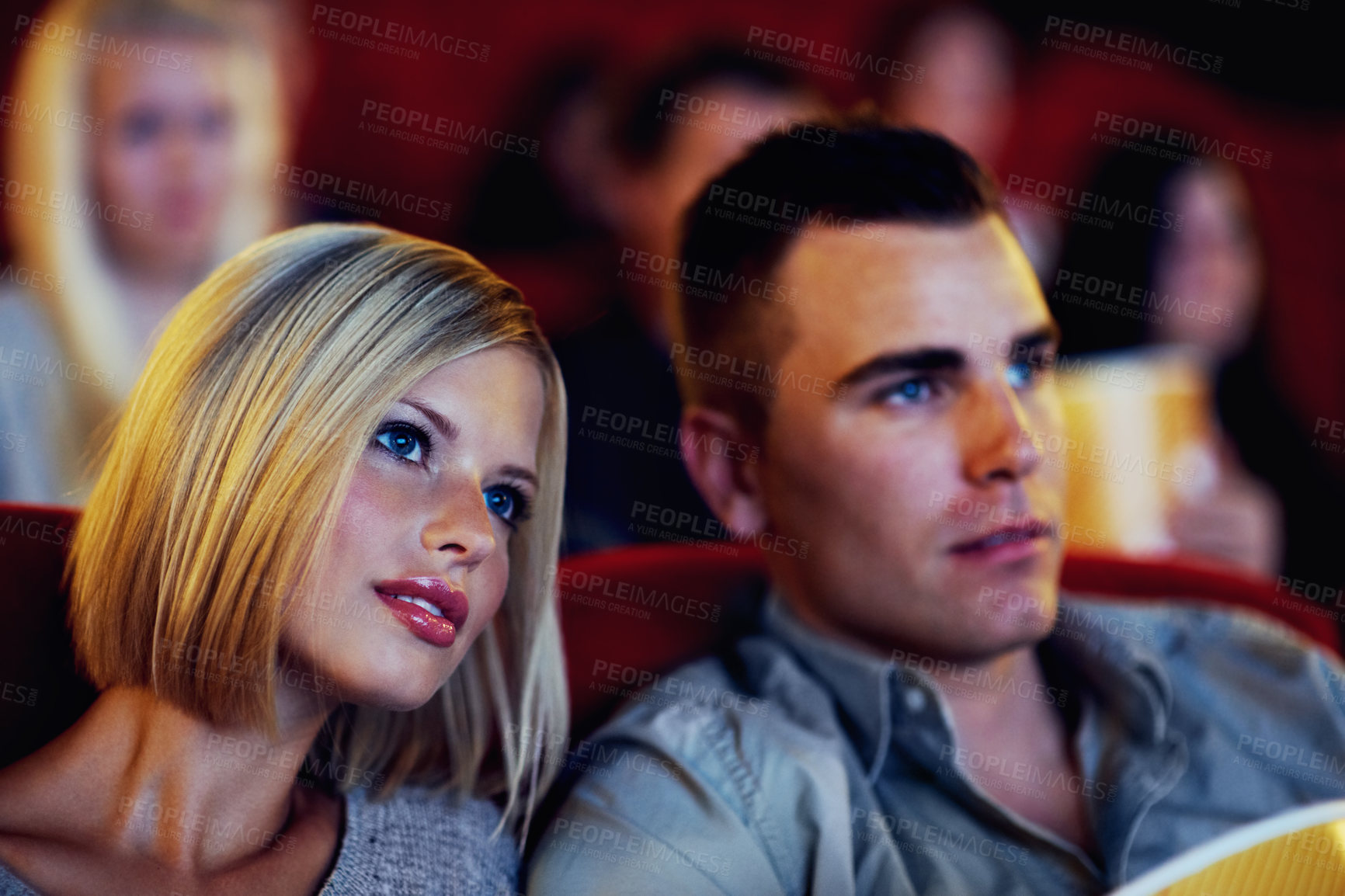 Buy stock photo Cinema, movie and couple watching film, entertainment and popcorn on romantic evening together. Date night, man and woman in Hollywood theater with snacks, show and sitting in auditorium to relax.
