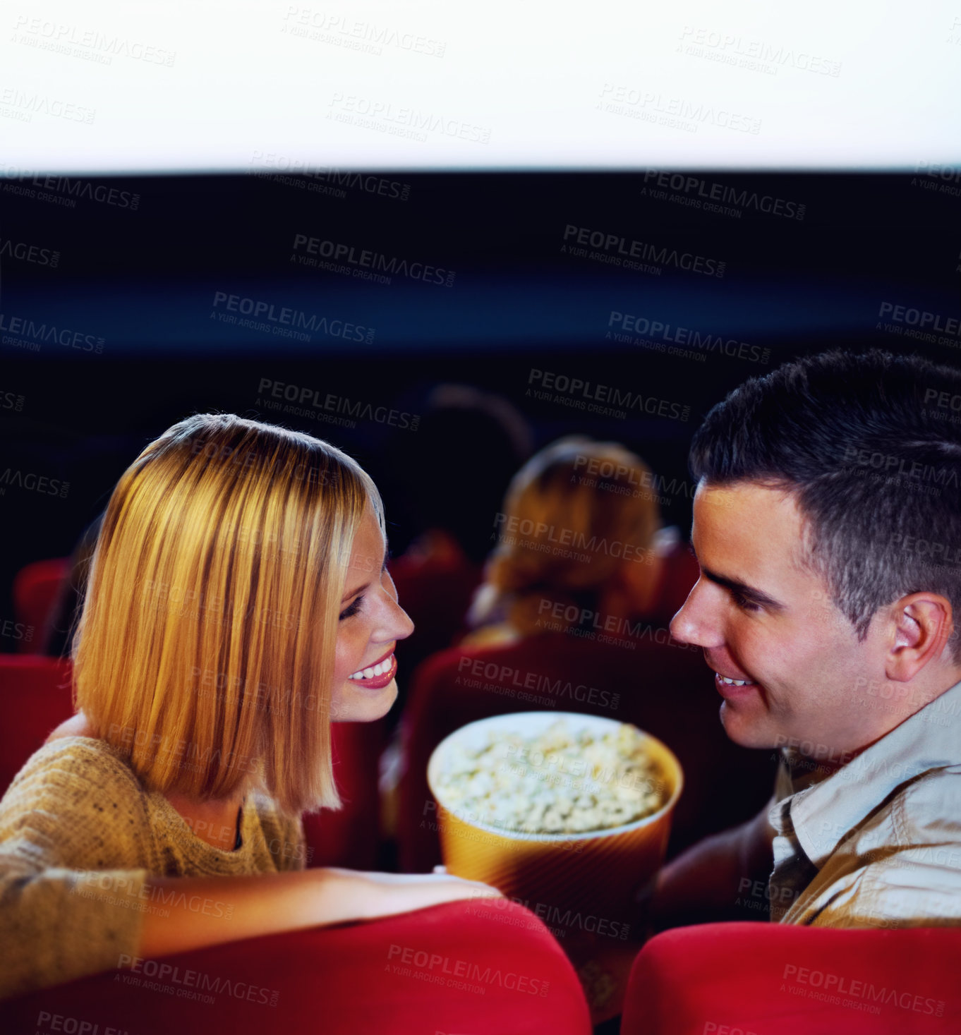 Buy stock photo Cinema, smile and couple with popcorn, watching film or eating on romantic date together. Movie night, happy man and woman in theater with snacks, love and sitting in auditorium to relax in audience