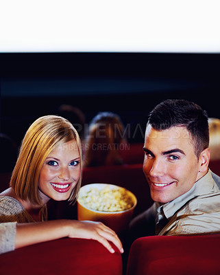 Buy stock photo Cinema, portrait of happy couple with popcorn, watching film or eating on romantic night together. Date, man and woman in movie theater with snacks, smile on face and sitting in auditorium to relax.