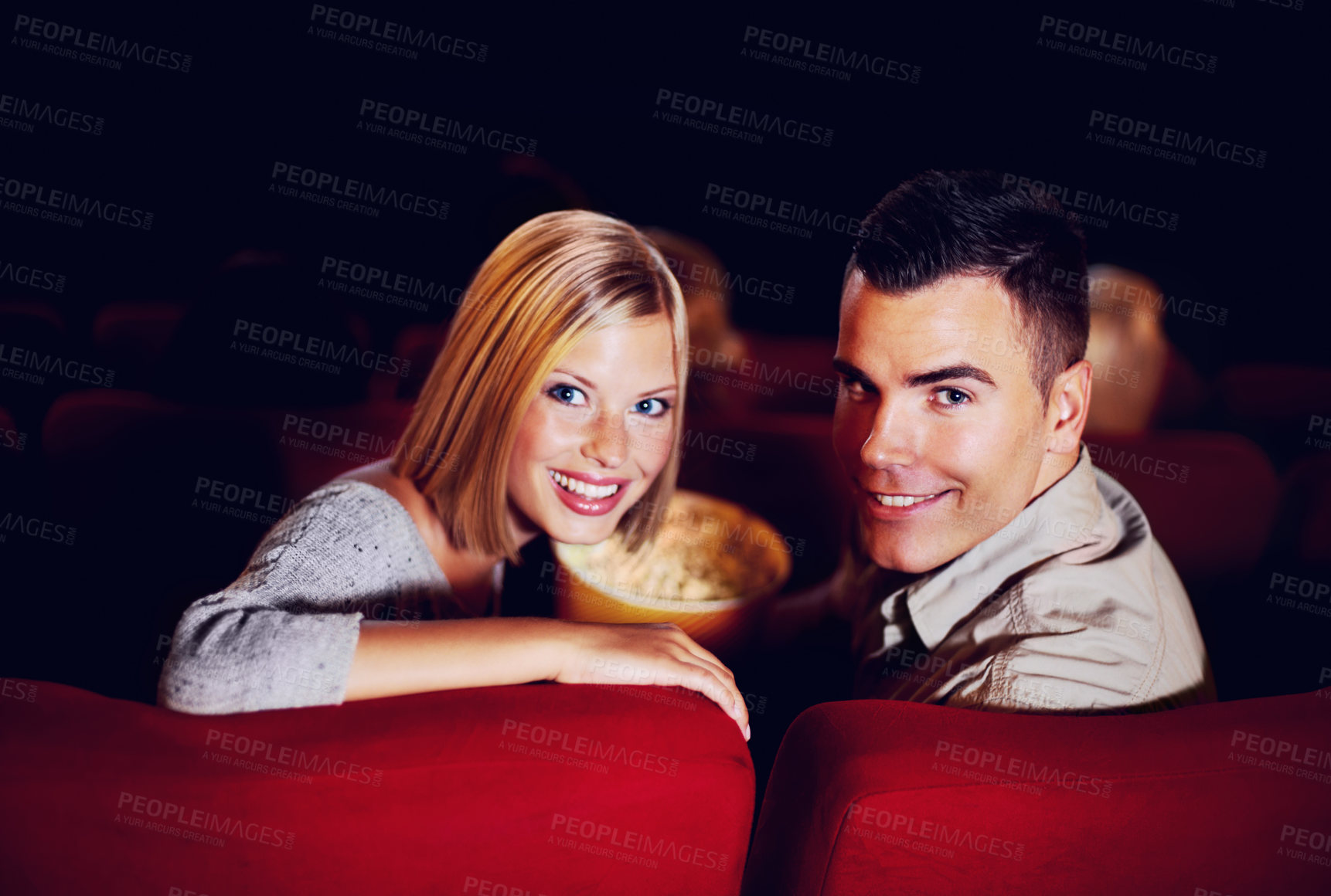 Buy stock photo Cinema, portrait and couple with popcorn on date, watching film or video on romantic night together. Movies, man and woman in theater with snacks, smile and sitting in auditorium to relax in audience