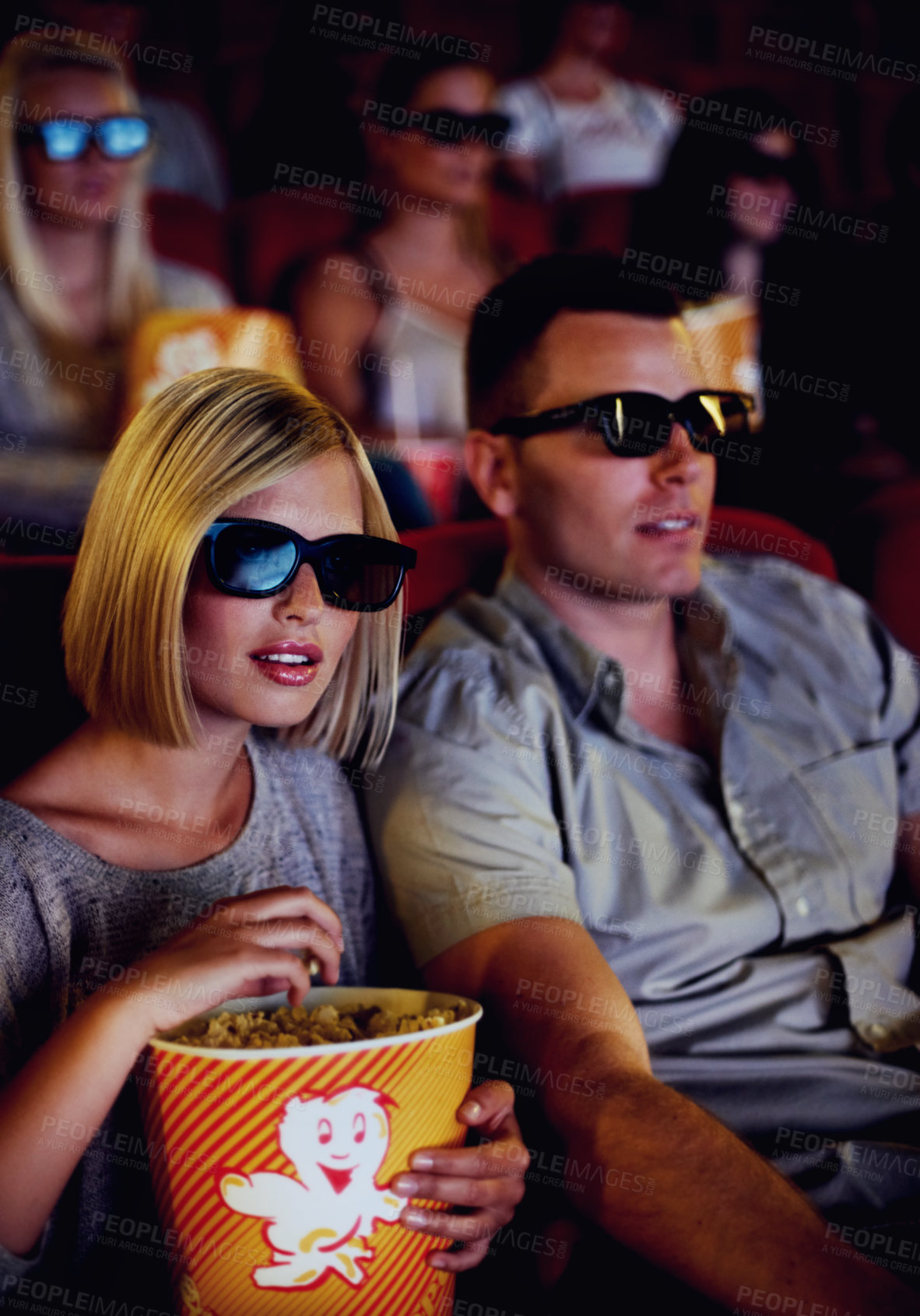 Buy stock photo Cinema, 3d glasses and couple with popcorn, watching film or eating on romantic date together. Movie night, man and woman in theater with snacks, eyewear and sitting in auditorium to relax at premier