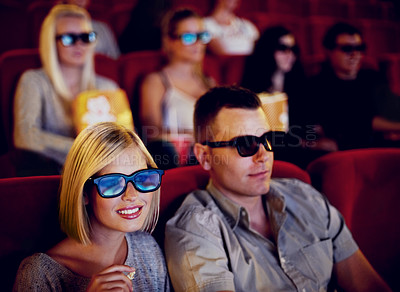 Buy stock photo Cinema, 3d glasses and couple watching film, eating popcorn and romantic date together. Movie night, man and woman with smile in theater, snacks and eyewear, sitting in auditorium to relax at show.