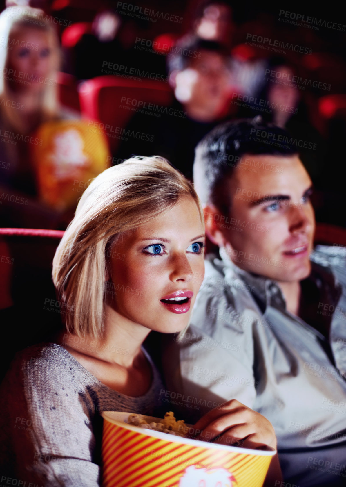 Buy stock photo Film, cinema and couple love popcorn at the movie theatre at night in a dark room for horror, action and scary entertainment. People, man and young woman watching romantic comedy together on date