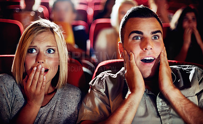Buy stock photo Couple watch a scary, horror or thriller movie in a cinema together and are shocked, wow or surprised. Man and woman in theatre on a date with omgand scared emotion or fear while watching a film