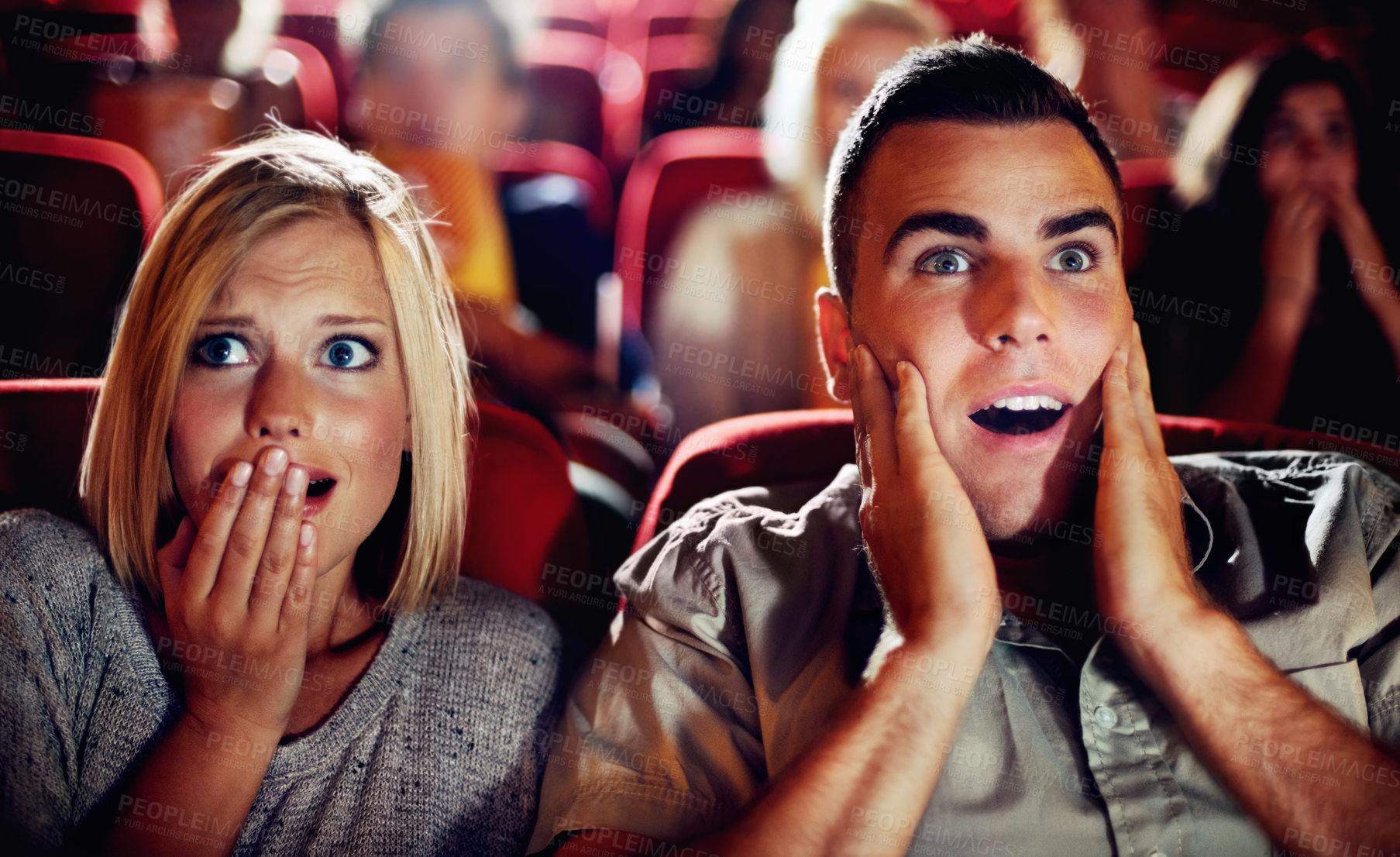 Buy stock photo Couple watch a scary, horror or thriller movie in a cinema together and are shocked, wow or surprised. Man and woman in theatre on a date with omgand scared emotion or fear while watching a film