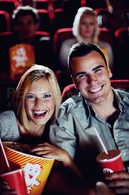 Buy stock photo Cinema, comedy and portrait of couple with popcorn, watching film or eating on romantic date together. Movie night, man and woman in theater with snacks, laughing and sitting in auditorium to relax