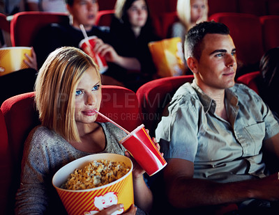 Buy stock photo Popcorn, date and a couple in a cinema together, watching a movie for entertainment or romance. Food, audience or love with a man and woman in theater to experience a film while eating a snack