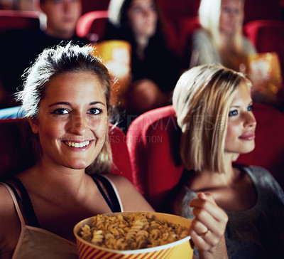 Buy stock photo Portrait, popcorn and a woman in the cinema watching a movie for entertainment while eating a snack. Face, smile and food with happy young friends in a theater audience to experience a film together