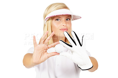 Buy stock photo Portrait, golf ball and white background of woman in studio with glove hands, sports uniform and face. Young female golfer showing equipment for games, action and hobby with skill, playing or golfing