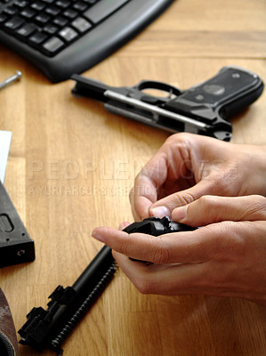 Buy stock photo Man, hands and bullet for a gun at a table with military training, battle and conflict. Army, police and pistol with a male tactical expert of a hero with weapon for shooting range and warrior gear 