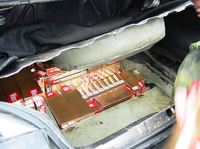 Buy stock photo A car boot stuffed full of cigarette cartons and boxes  -  This is the real thing from KFOR, Kosovo 1999. This image is part of our historic collection. The digital cameras available back then where very bad, so expect exceptionally bad image quality