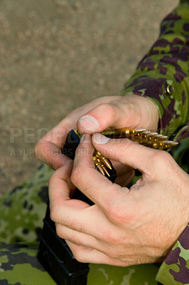 Buy stock photo Man, soldier hands and bullet for a gun outdoor with military training, battle and conflict. Army, war and field with a male tactical expert of a hero with weapon for shooting range and warrior gear 