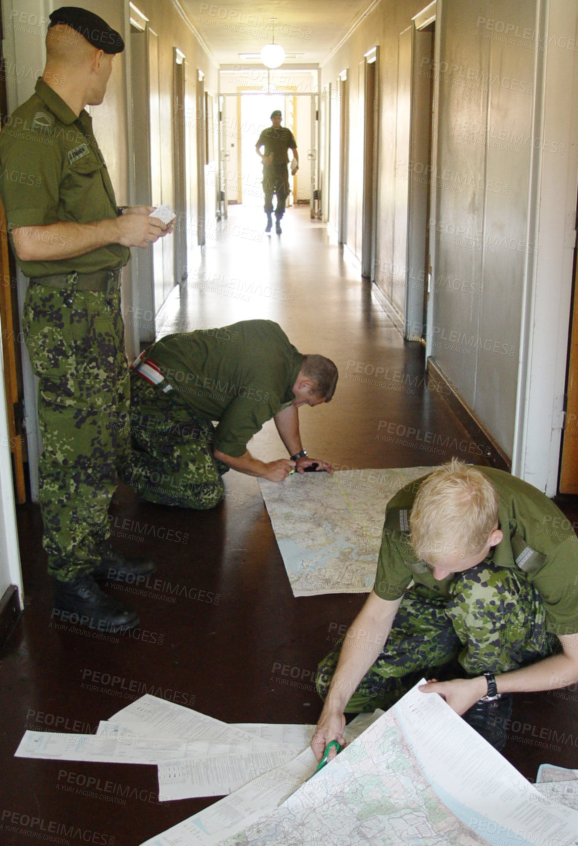 Buy stock photo Army, war and map with a soldier team planning a battle strategy in the hallway of their military base. Training, teamwork and camouflage with personnel getting ready for problem solving in uniform