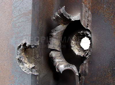 Buy stock photo Closeup bullet hole, the real thing from KFOR, Kosovo 1999. Broken steel and pierced armour are the evidence of a fight, battle or war. Weapons of mass destruction can cause irreparable damage