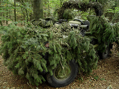 Buy stock photo Forest, war and an army vehicle in camouflage for an attack or ambush during a special forces mission. Nature, military and a car covered in grass in the countryside for training as a soldier