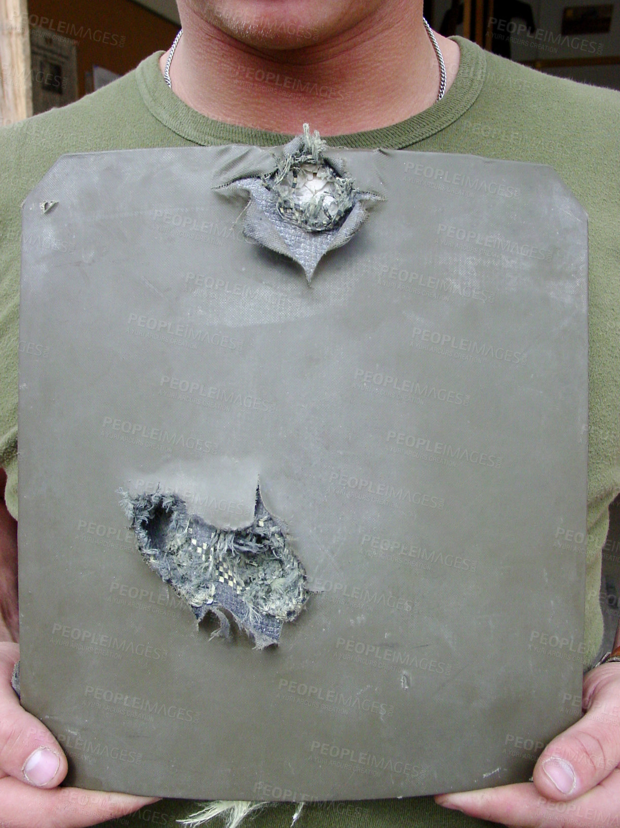 Buy stock photo Shot of a soldier holding up pierced body armor- this is the real thing from KFOR, Kosovo 1999. This image is part of our historic collection. The digital cameras available back then where very bad, so expect exceptionally bad image quality