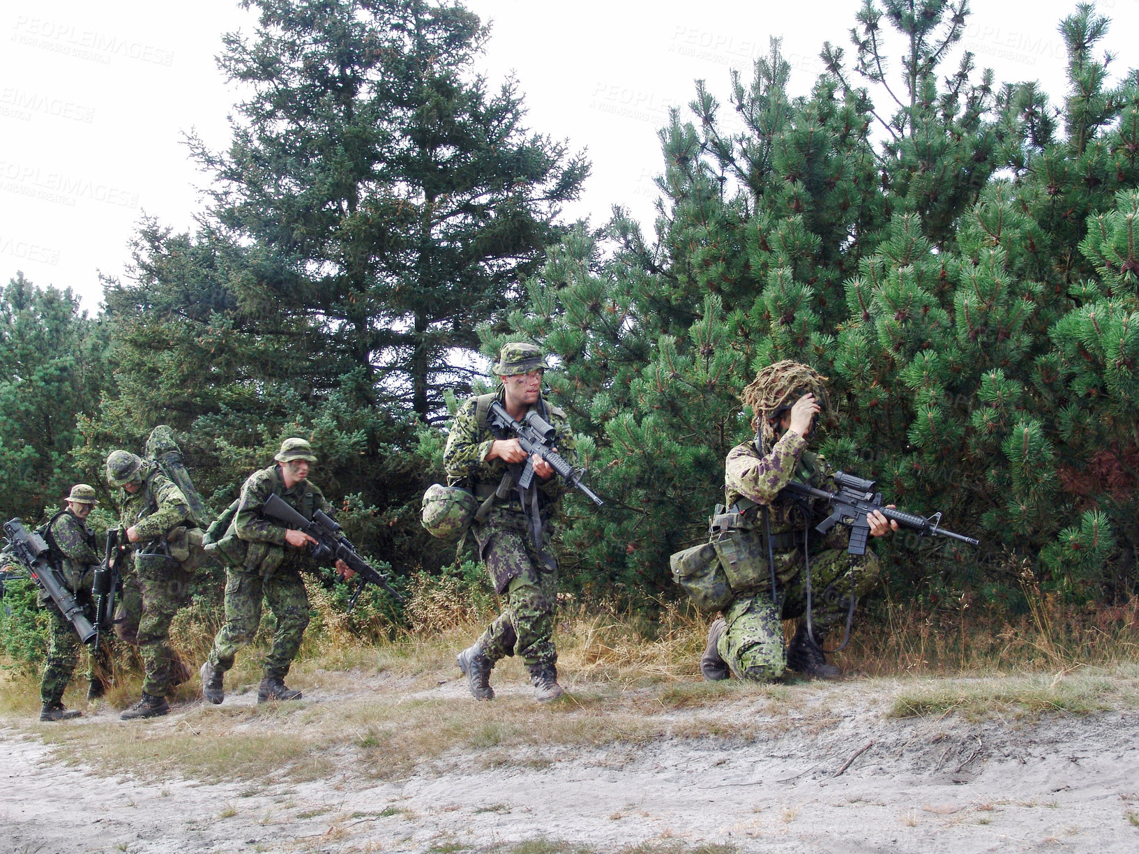 Buy stock photo A squad of soldiers running through the forest fully-armed