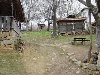 Buy stock photo Farm, forest and a wood cabin on a path in Kosovo during 1999 after conflict during war or battle. Agriculture, sustainability and village with a house or barn in the woods on a nature landscape