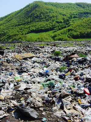 Buy stock photo Pollution, waste or refuse with litter in nature against a green mountain as a danger of climate change. Global warming, garbage and trash, toxic to the environment on an illegal dump or landfill