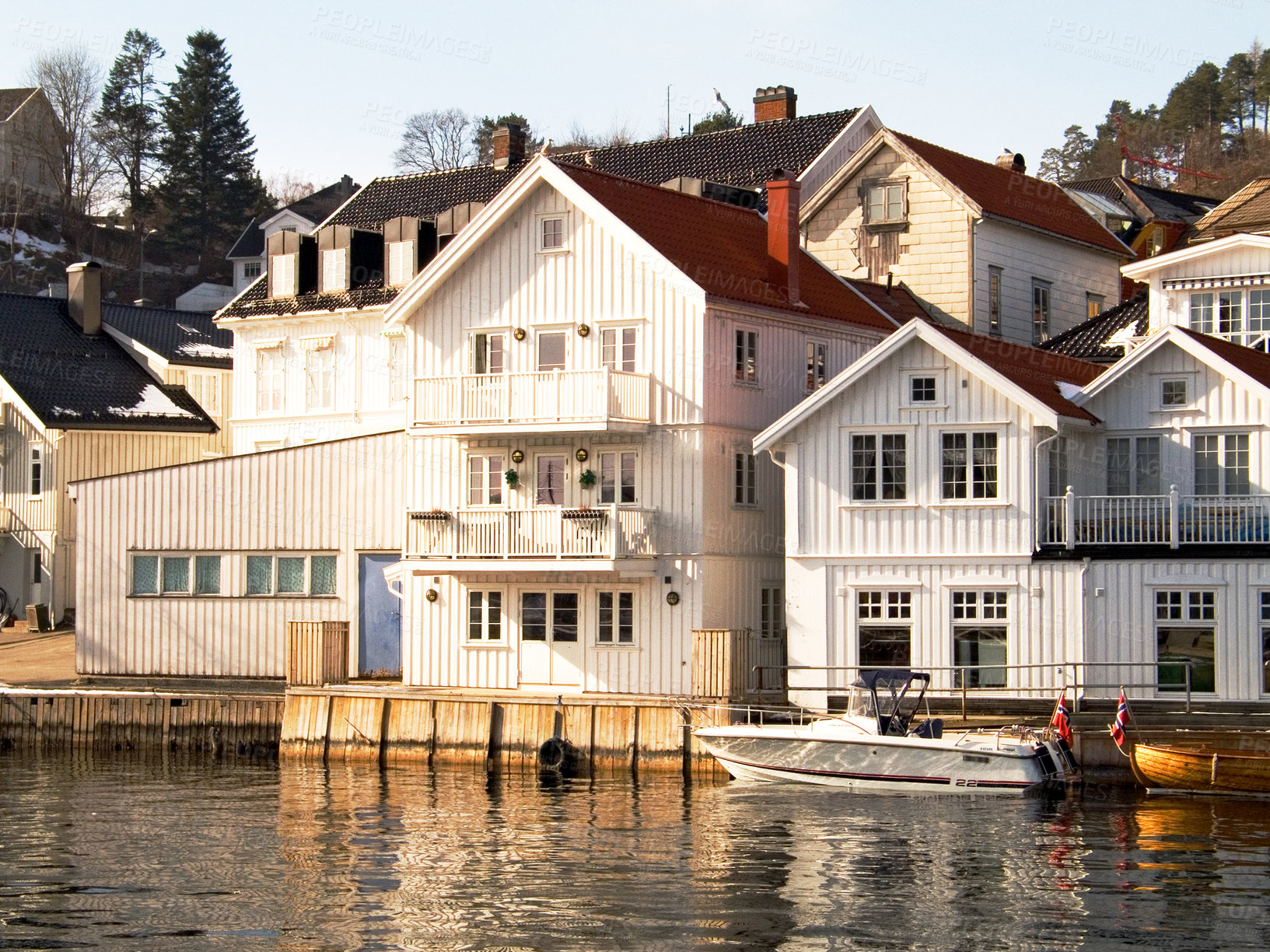 Buy stock photo Facade, water and home by lake in Norway, Europe and boat for tourism, travel or vacation. Exterior, house and Scandinavian building by river, vintage architecture or traditional property real estate