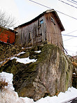 Old wooden cabin on a rocky outcrop
