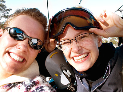 Buy stock photo A happy young couple about to go up a ski lift