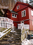 Red home in the snow - Winter Lodgings