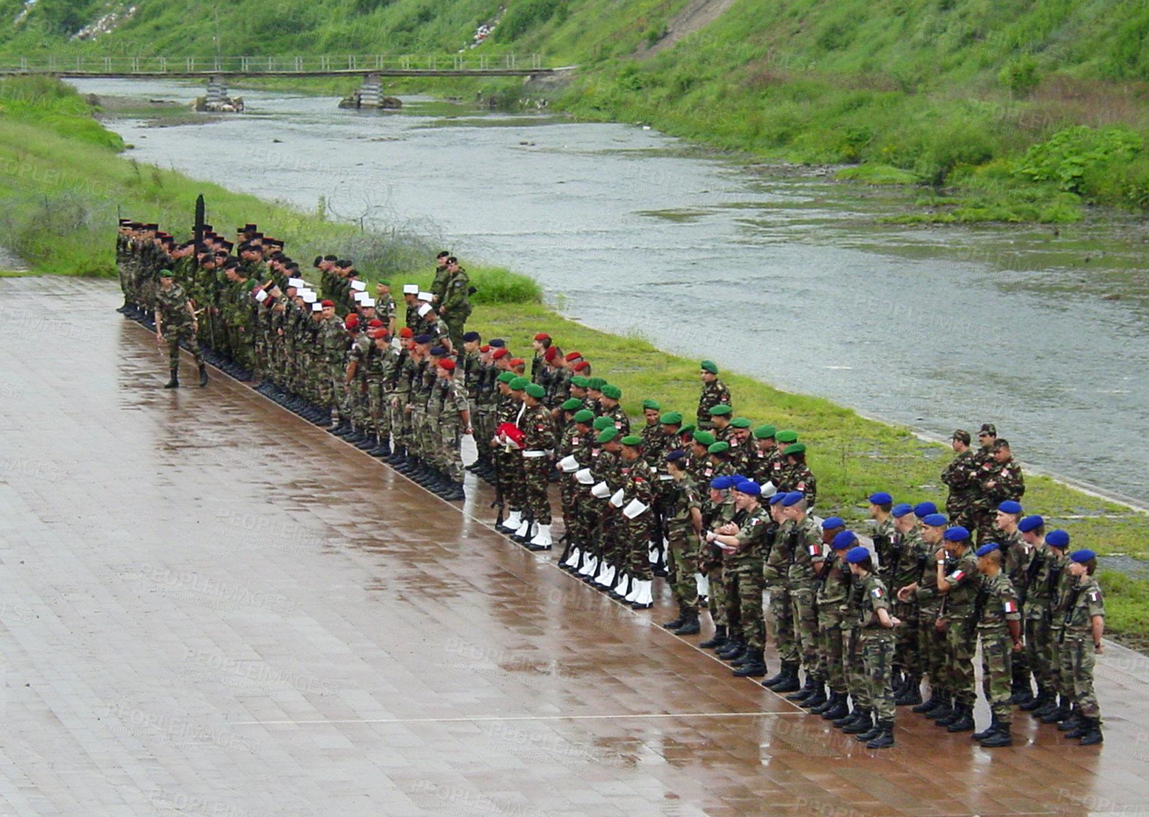 Buy stock photo Military, training or bootcamp with people in the rain for a drill at a parade as a special forces squad. Army, soldier and a group of personnel in camouflage uniform at attention by a river